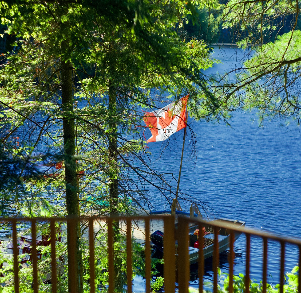 Canadian flag flying over a dock on an Ontario lake